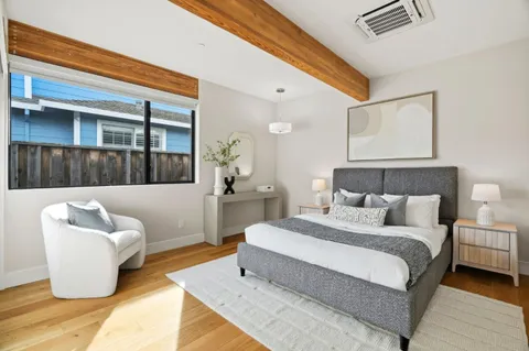 a bedroom with bed and a couch