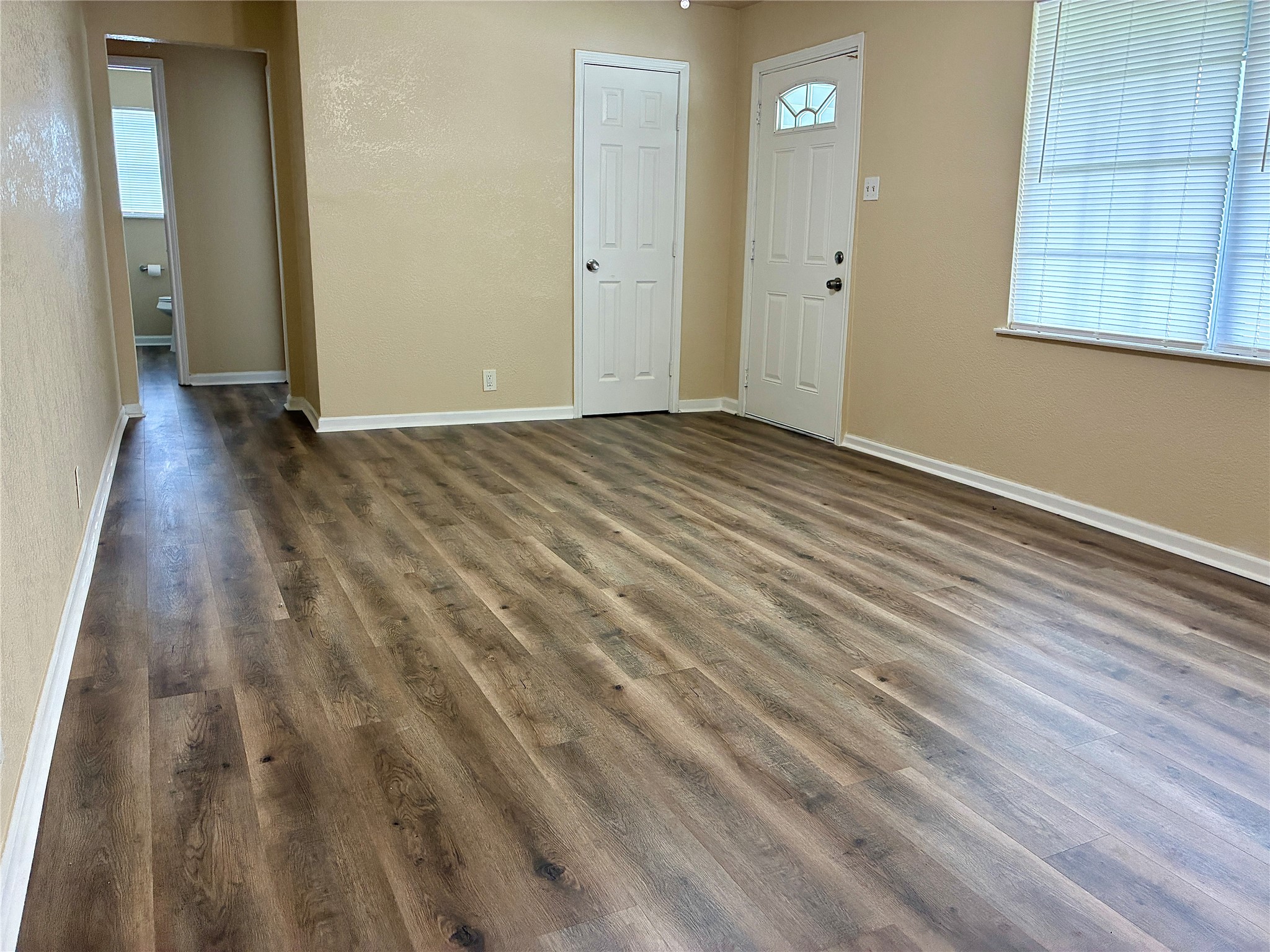 631 Roper Street Houston, TX 77034 - Photo 6 of 15 The living room features fresh paint, new vinyl plank flooring, and a new ceiling fan.