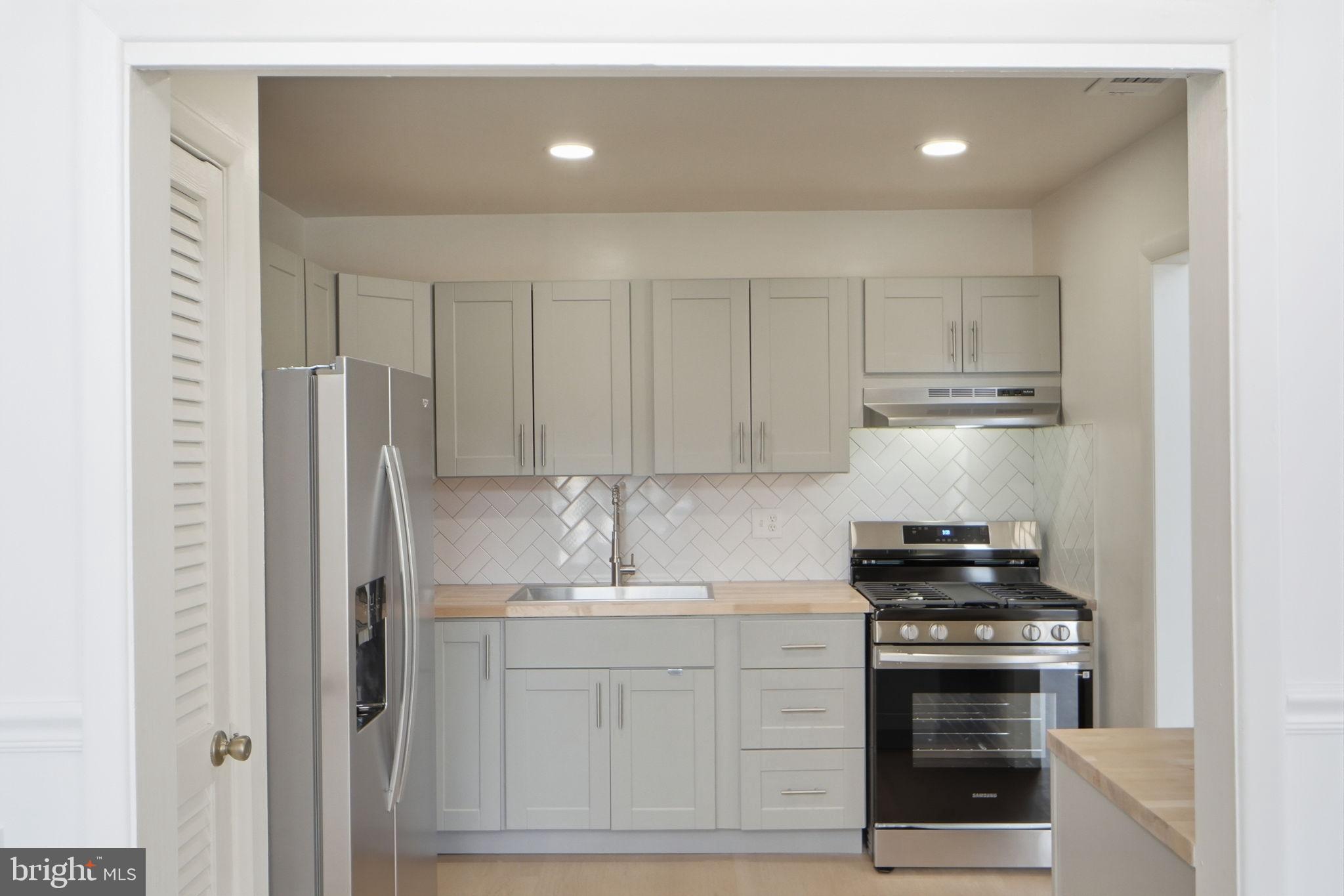 14427 Parkvale Road, Unit 7 Rockville, MD 20853 - Photo 11 of 43 Modern kitchen with sleek cabinetry.