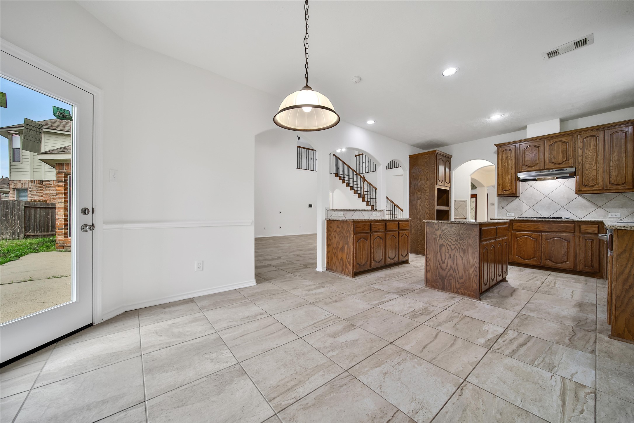 714 Stubbs Bend Drive Rosenberg, TX 77469 - Photo 16 of 42 a view of a kitchen with kitchen island wooden floor stainless steel appliances and cabinets