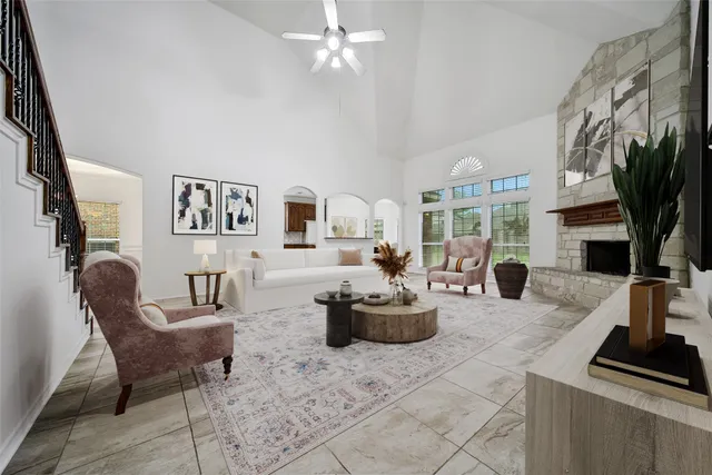 a view of empty room with a fireplace and fan