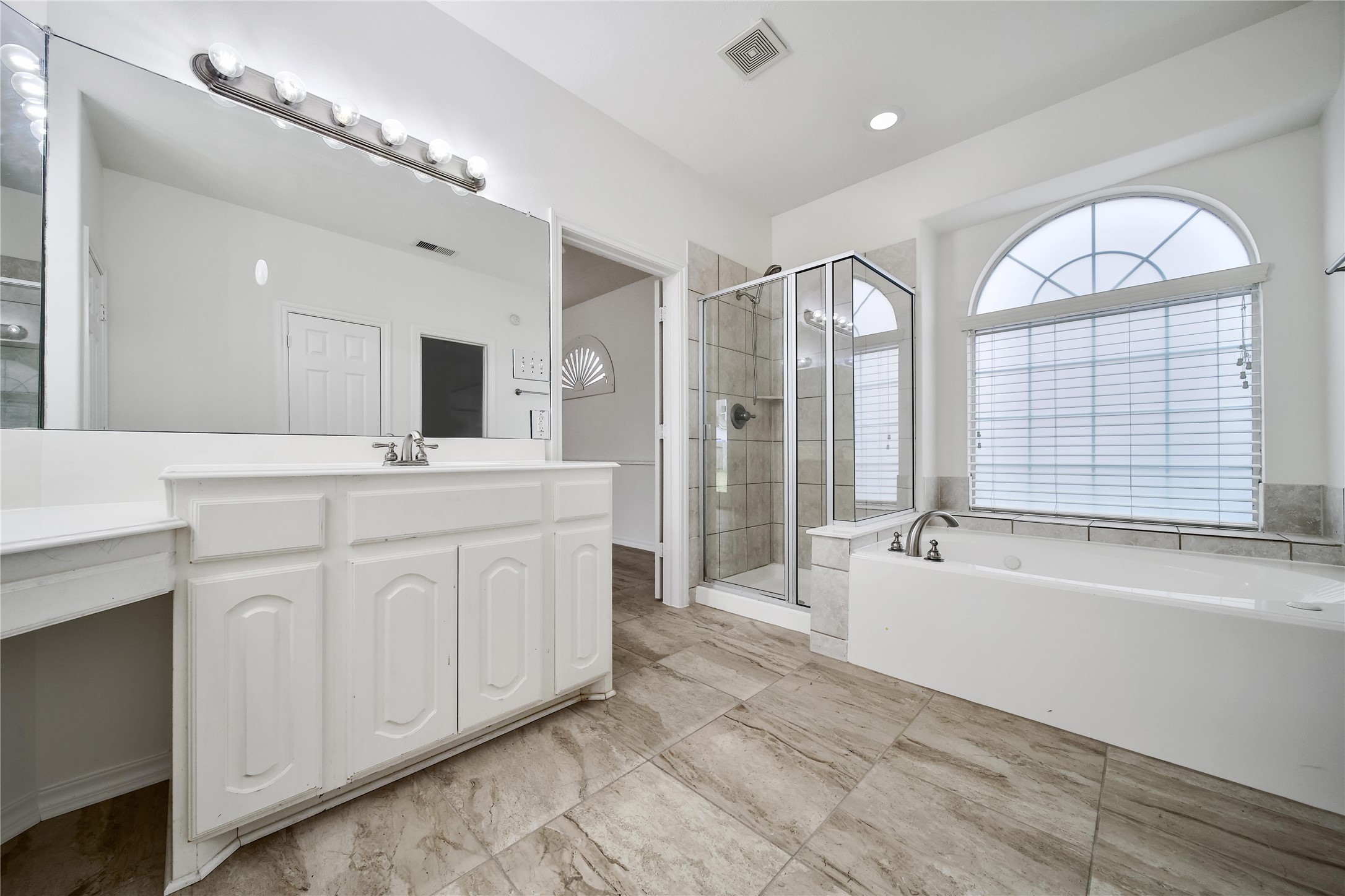 714 Stubbs Bend Drive Rosenberg, TX 77469 - Photo 36 of 42 a spacious bathroom with a double vanity sink a mirror and a bathtub