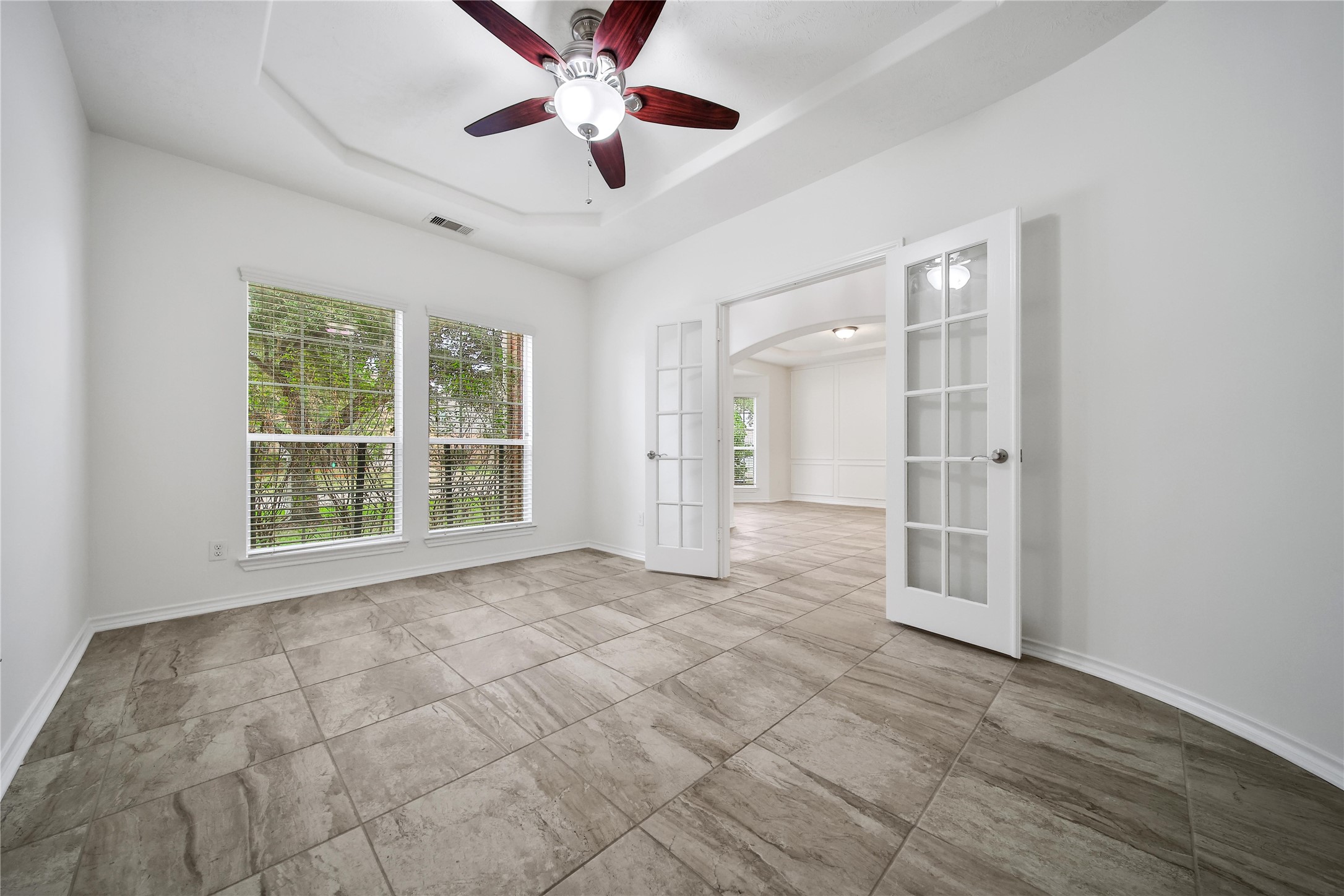 714 Stubbs Bend Drive Rosenberg, TX 77469 - Photo 8 of 42 an empty room with chandelier fan and windows