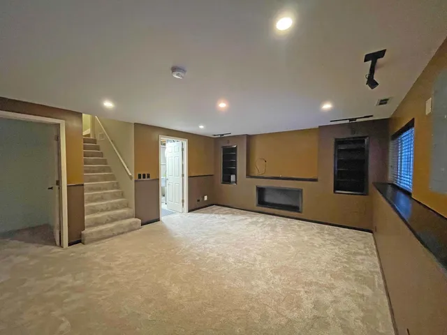 a view of an empty room with a fireplace