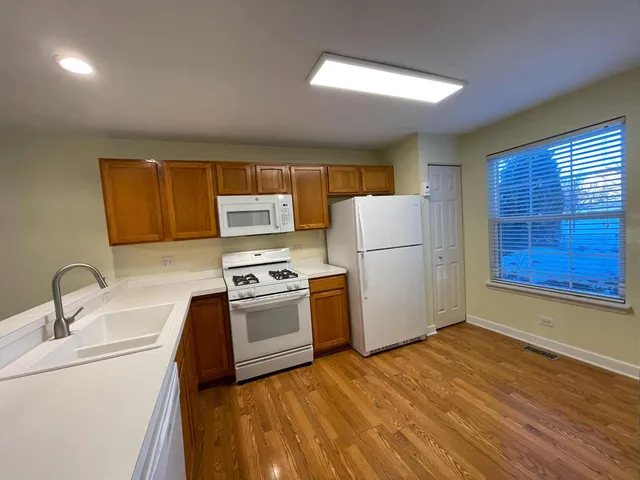 a kitchen with a refrigerator sink stove and microwave