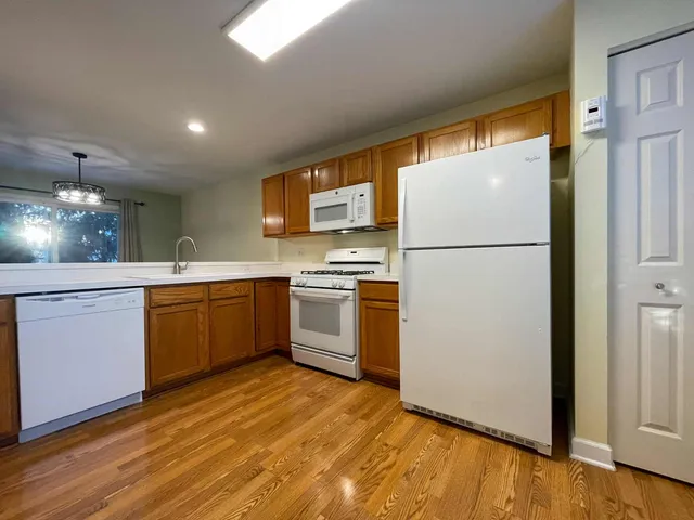 a kitchen with a refrigerator sink and cabinets
