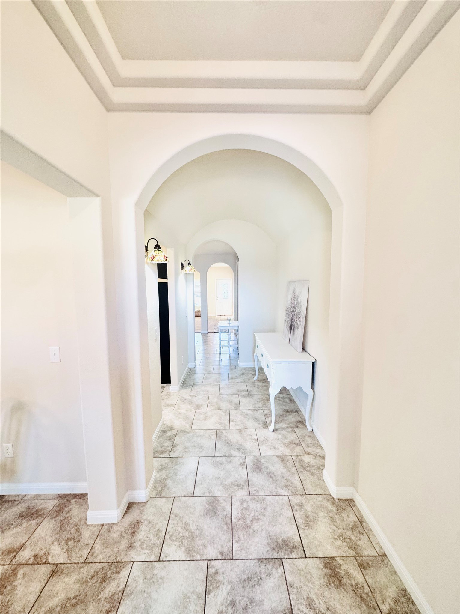 413 Gettysburg Loop Elgin, TX 78621 - Photo 4 of 32 Hall featuring a tray ceiling and arched walkways