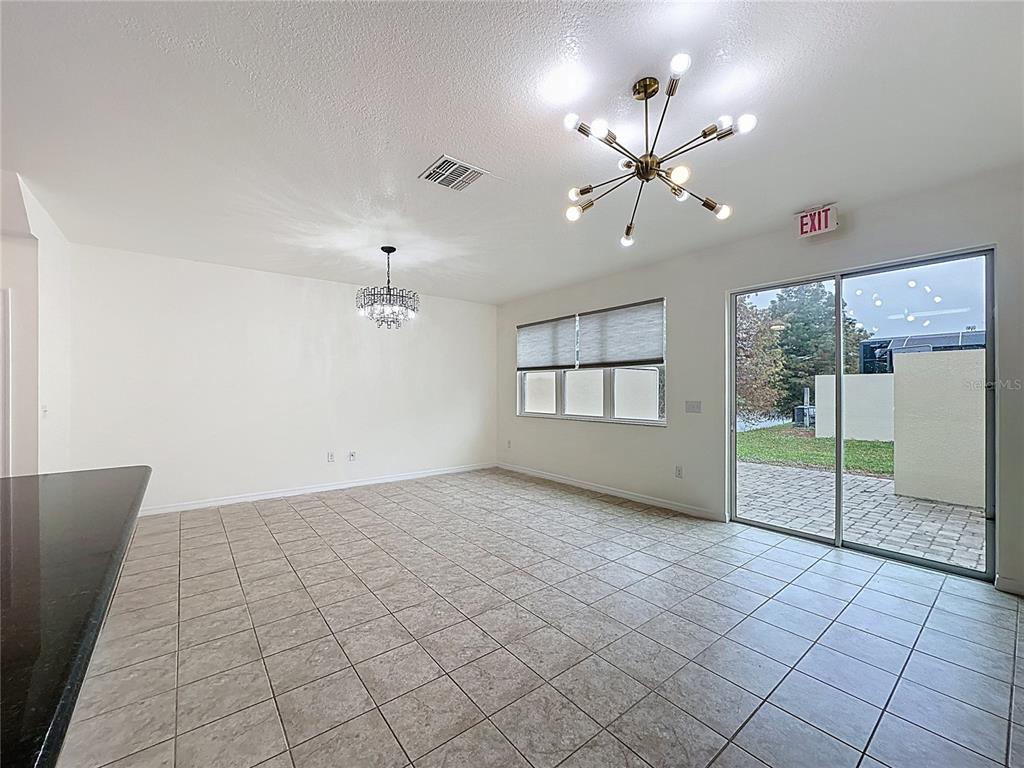 3135 Tocoa Circle Kissimmee, FL 34746 - Photo 15 of 36 a view of an empty room with window and chandelier fan