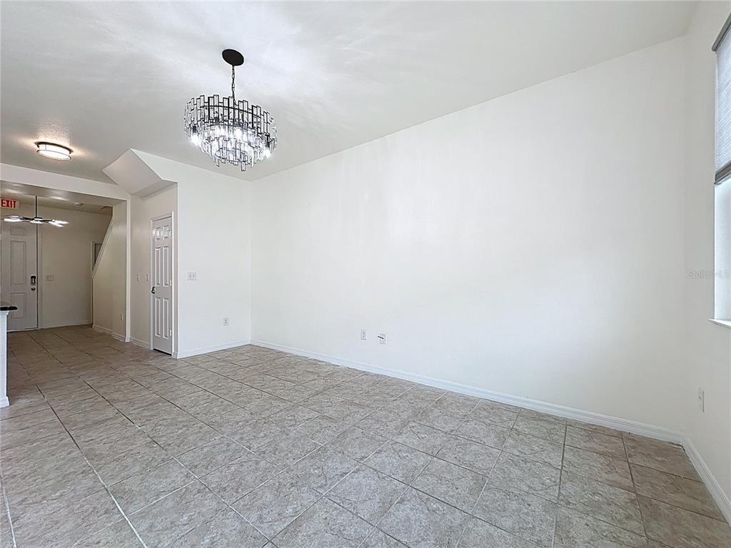 3135 Tocoa Circle Kissimmee, FL 34746 - Photo 18 of 36 a view of a room with a chandelier fan and windows