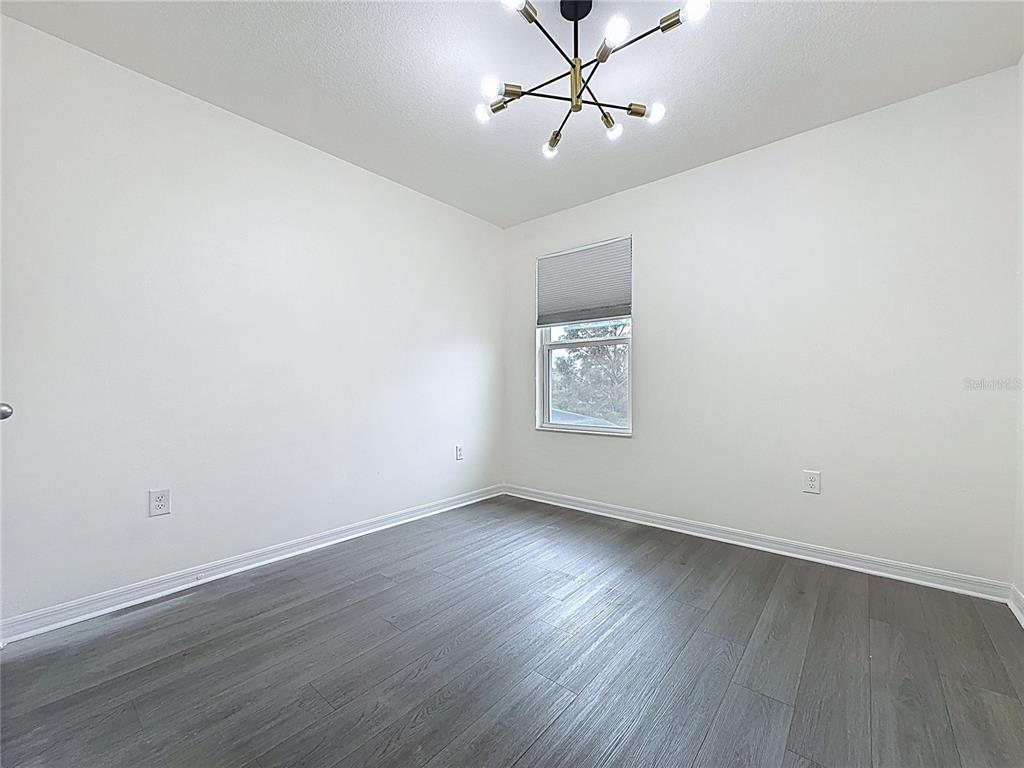 3135 Tocoa Circle Kissimmee, FL 34746 - Photo 19 of 36 a view of empty room with wooden floor and fan