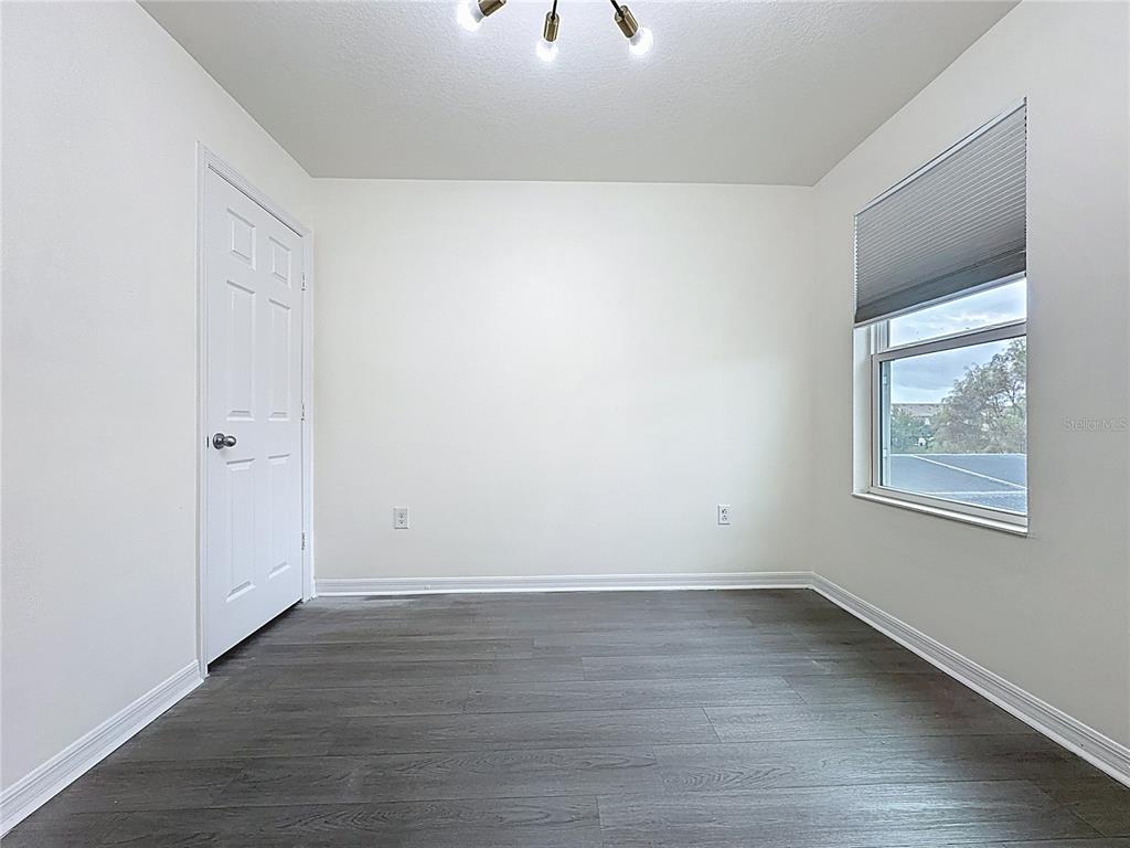 3135 Tocoa Circle Kissimmee, FL 34746 - Photo 25 of 36 an empty room with wooden floor and windows