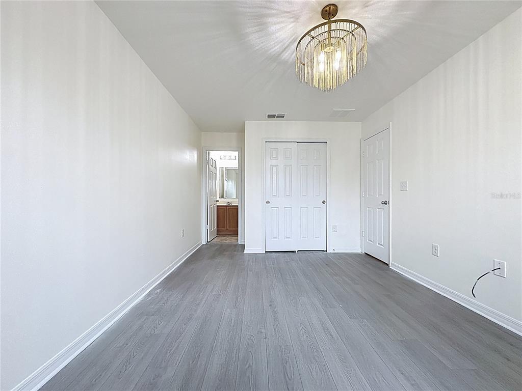3135 Tocoa Circle Kissimmee, FL 34746 - Photo 27 of 36 a view of an empty room with wooden floor