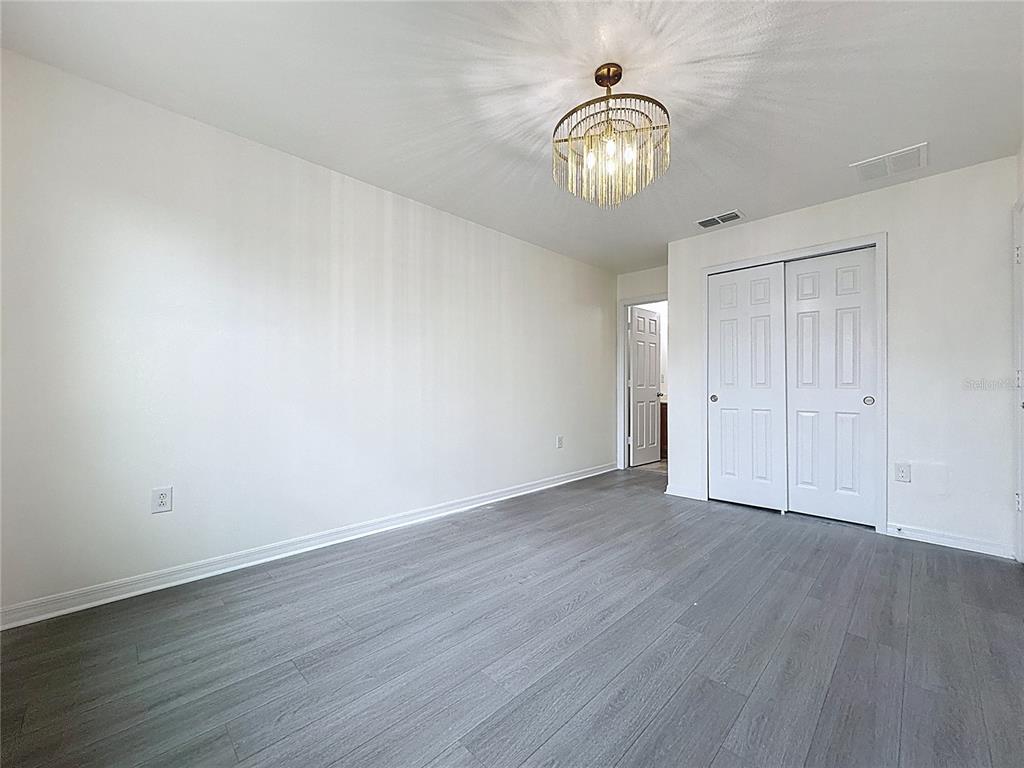 3135 Tocoa Circle Kissimmee, FL 34746 - Photo 28 of 36 a view of an empty room with wooden floor