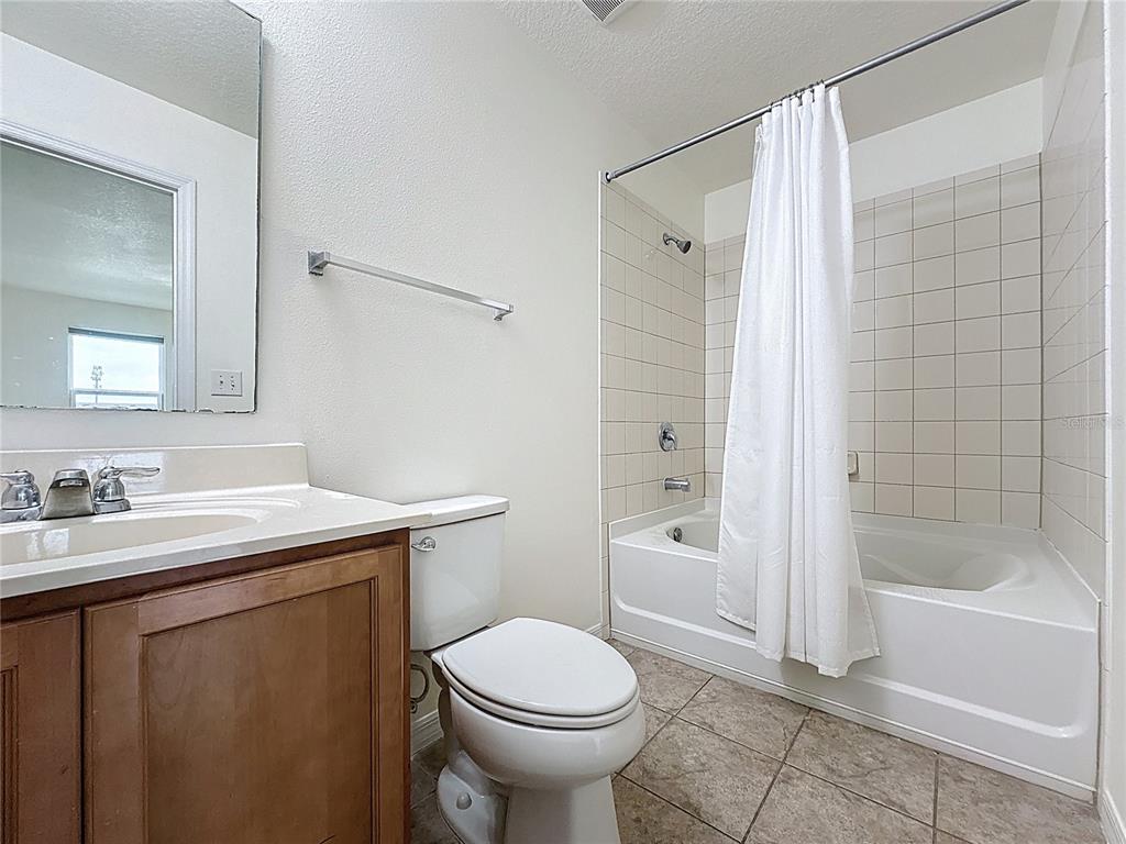 3135 Tocoa Circle Kissimmee, FL 34746 - Photo 29 of 36 a bathroom with a sink toilet and shower