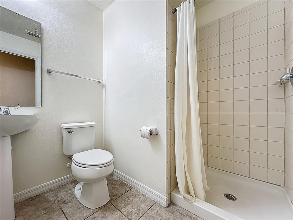 3135 Tocoa Circle Kissimmee, FL 34746 - Photo 30 of 36 a bathroom with a toilet and a shower