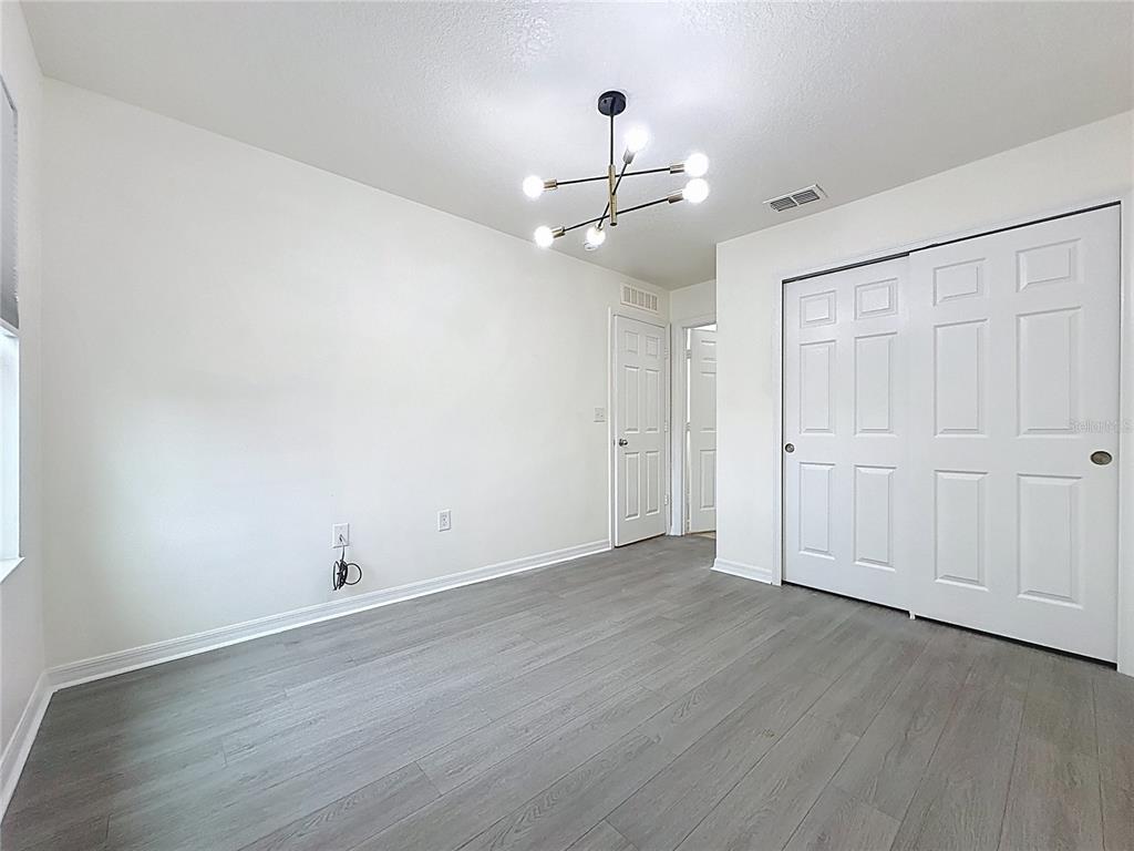 3135 Tocoa Circle Kissimmee, FL 34746 - Photo 33 of 36 a view of an empty room with wooden floor