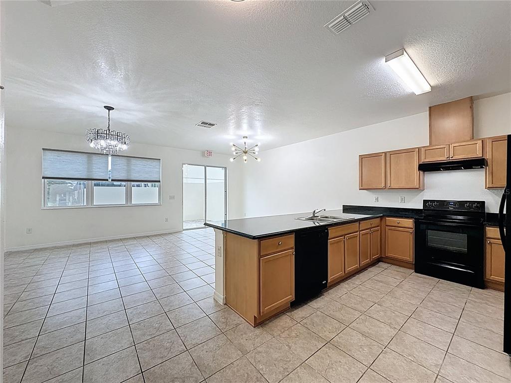 3135 Tocoa Circle Kissimmee, FL 34746 - Photo 5 of 36 a large kitchen with stainless steel appliances granite countertop a stove and cabinets