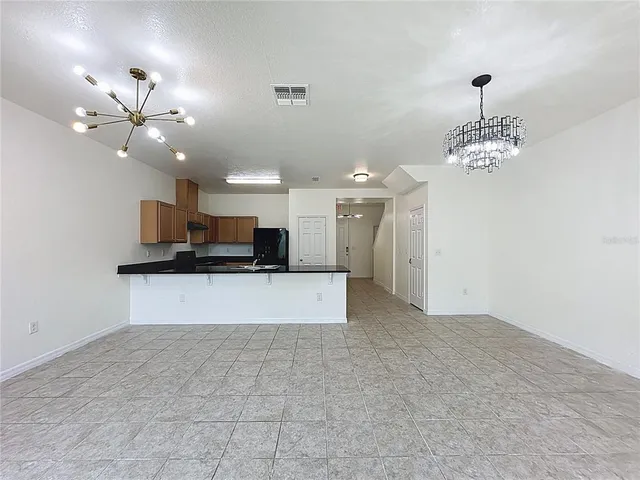 a view of a kitchen with a stove and a chandelier