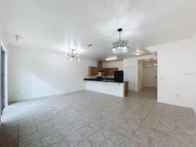 a view of a kitchen with a sink and a chandelier
