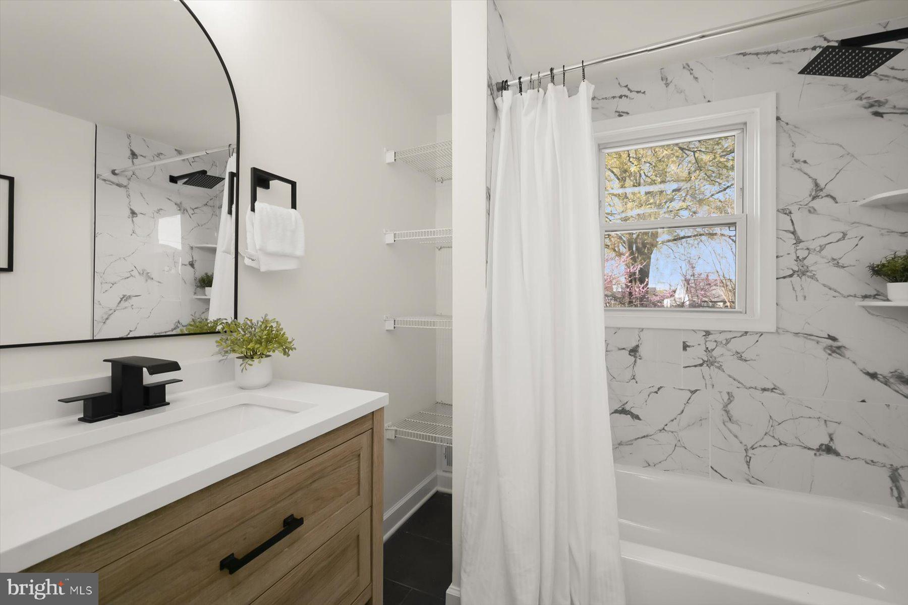 518 Church Street Baltimore, MD 21225 - Photo 15 of 27 a bathroom with a bathtub sink and mirror