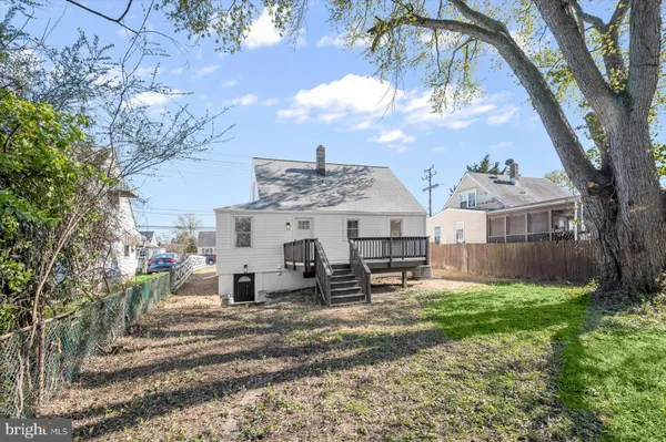 a view of a house with backyard and deck