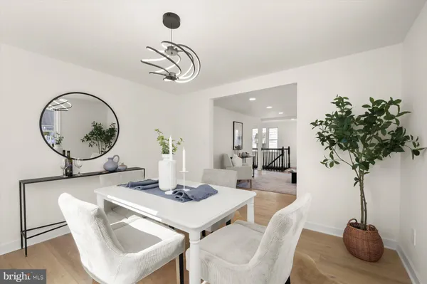 a dining room with furniture and a mirror