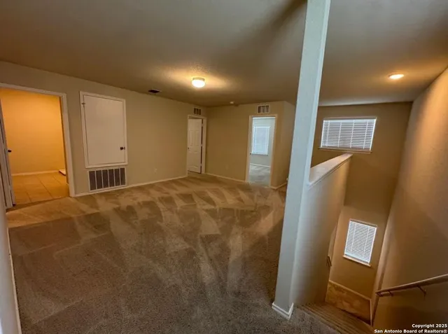 a view of backyard with wooden fence