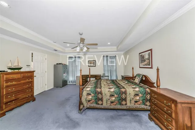 a spacious bedroom with a bed and a chandelier