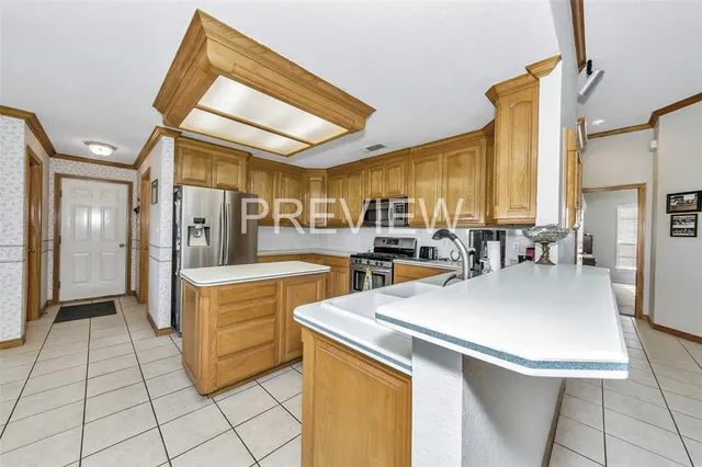 a kitchen with a sink a stove and chairs