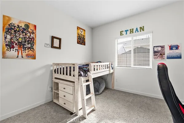 a view of a bedroom with furniture and windows