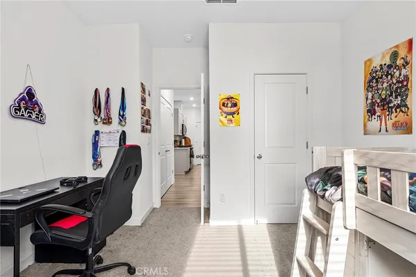 a view of a hallway with workspace and a couch