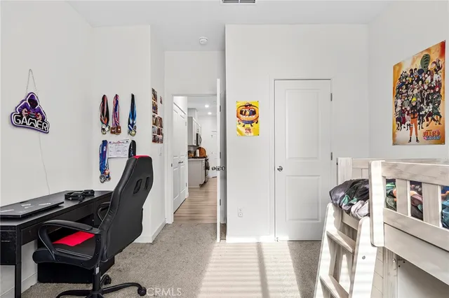 a view of a hallway with workspace and a couch