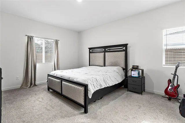 a spacious bedroom with a bed and a window