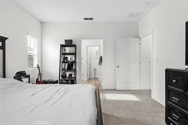 a bedroom with a bed and a closet