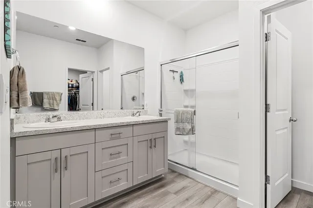 a bathroom with a granite countertop sink mirror and double