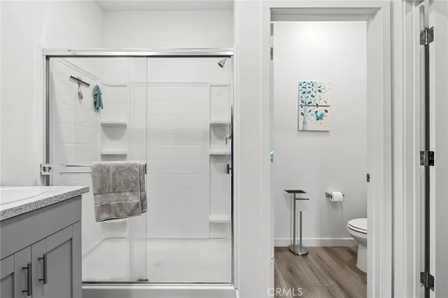 a bathroom with a shower and a sink