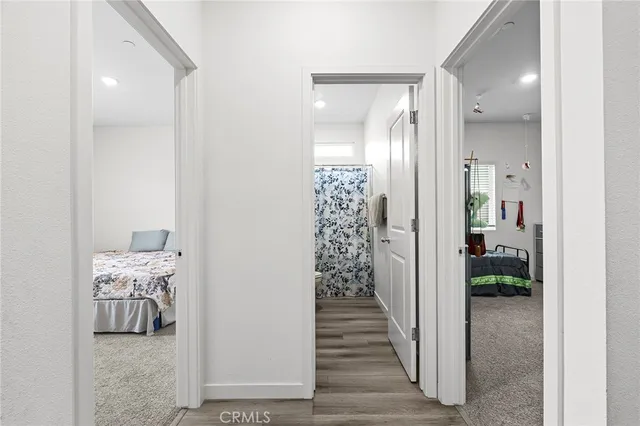 a view of a hallway with closet and wooden floor