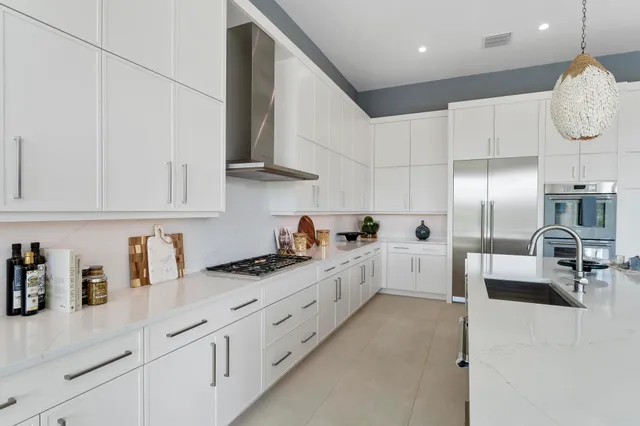 a kitchen with granite countertop white cabinets and white appliances