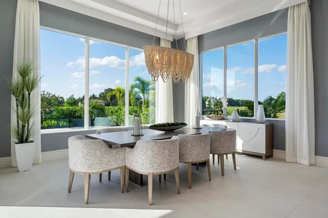 a dining room with furniture and a floor to ceiling window