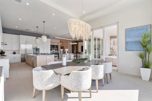 a spacious bedroom with a bed and a chandelier