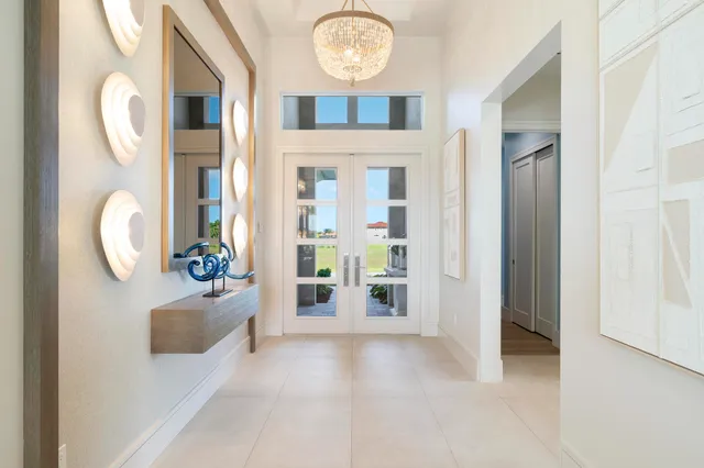 a view of a hallway with entryway dining room and front door