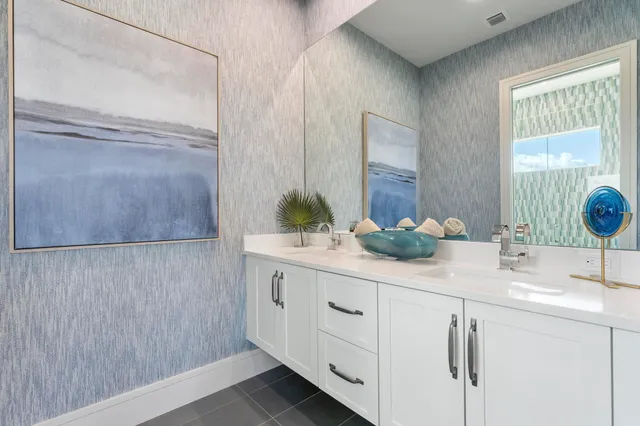 a living room with patio furniture and a garden