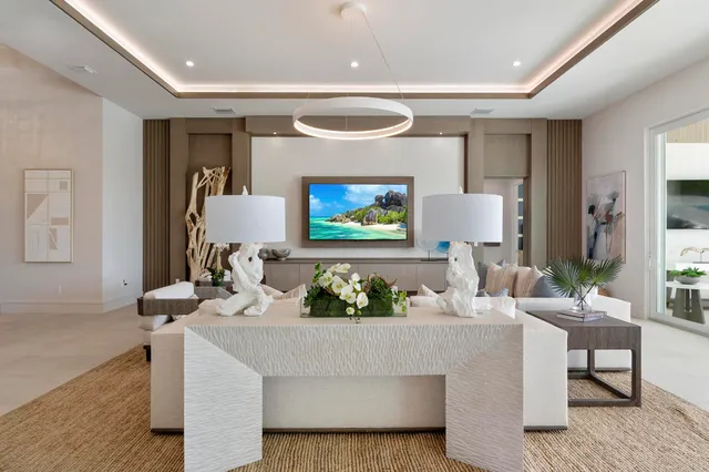 a living room with fireplace furniture and a potted plant