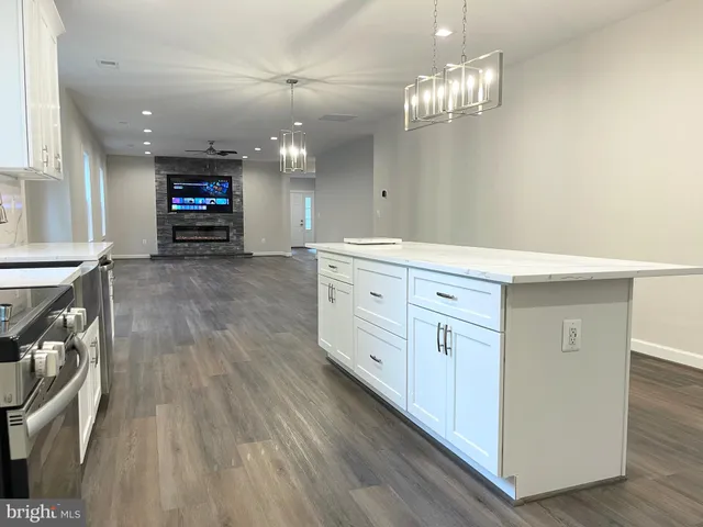 a view of a kitchen counter space and wooden floor