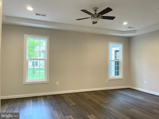 a view of a livingroom with a hardwood floor and a ceiling fan