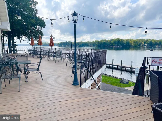 a kitchen with a dining table chairs and large windows
