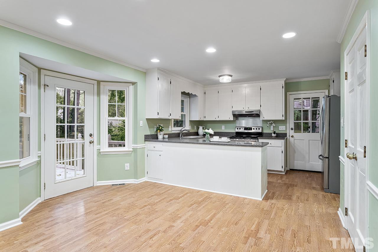 7416 Old Fox Trail Raleigh, NC 27613 - Photo 15 of 26 a kitchen with white cabinets and refrigerator
