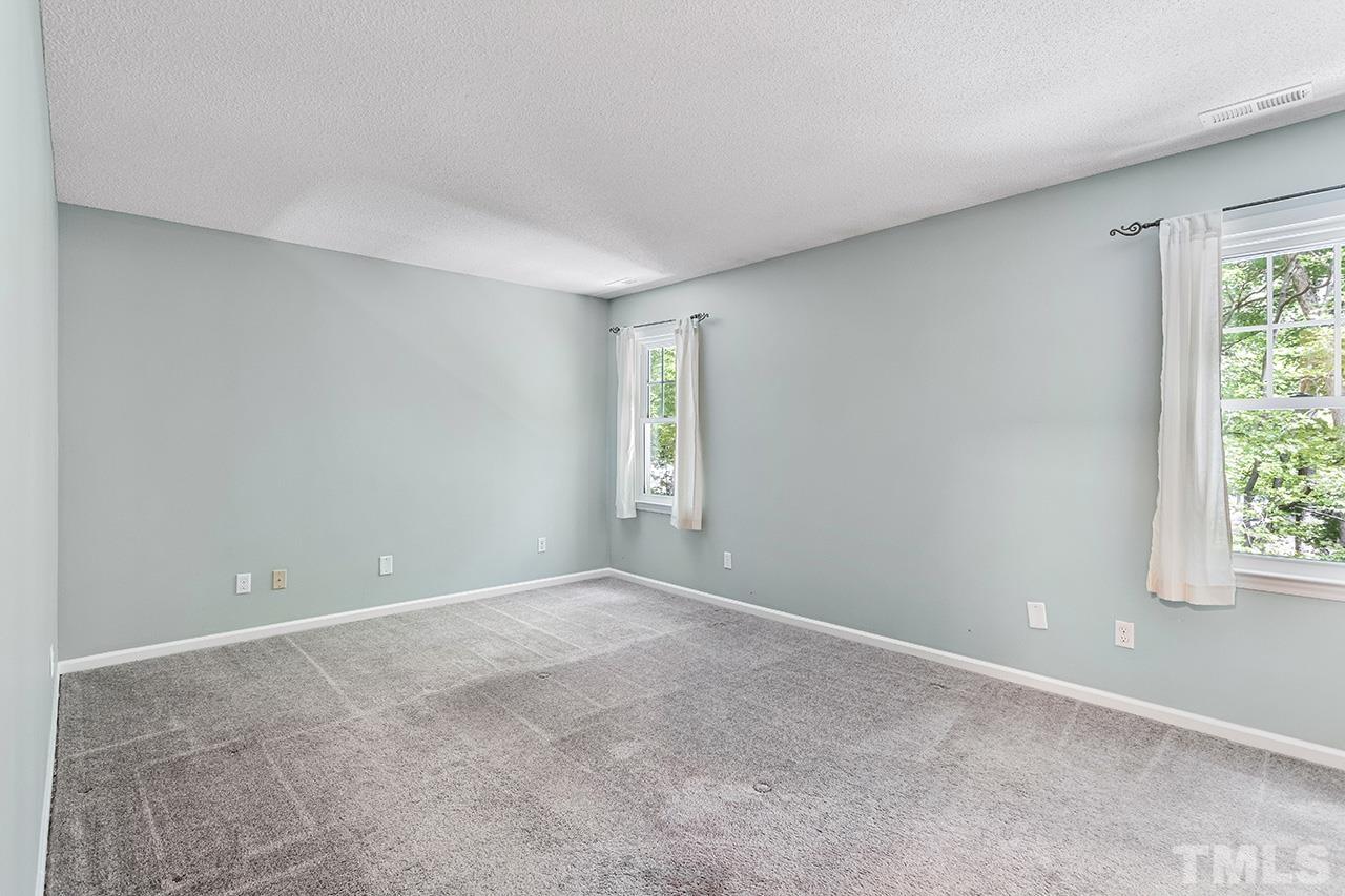 7416 Old Fox Trail Raleigh, NC 27613 - Photo 23 of 26 a view of an empty room with a window