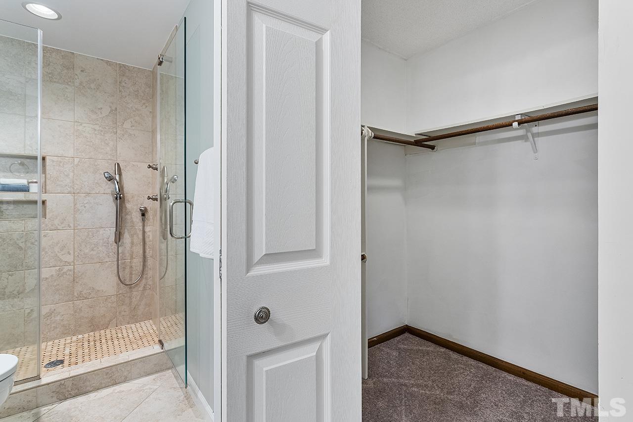 7416 Old Fox Trail Raleigh, NC 27613 - Photo 26 of 26 a bathroom with a glass shower door