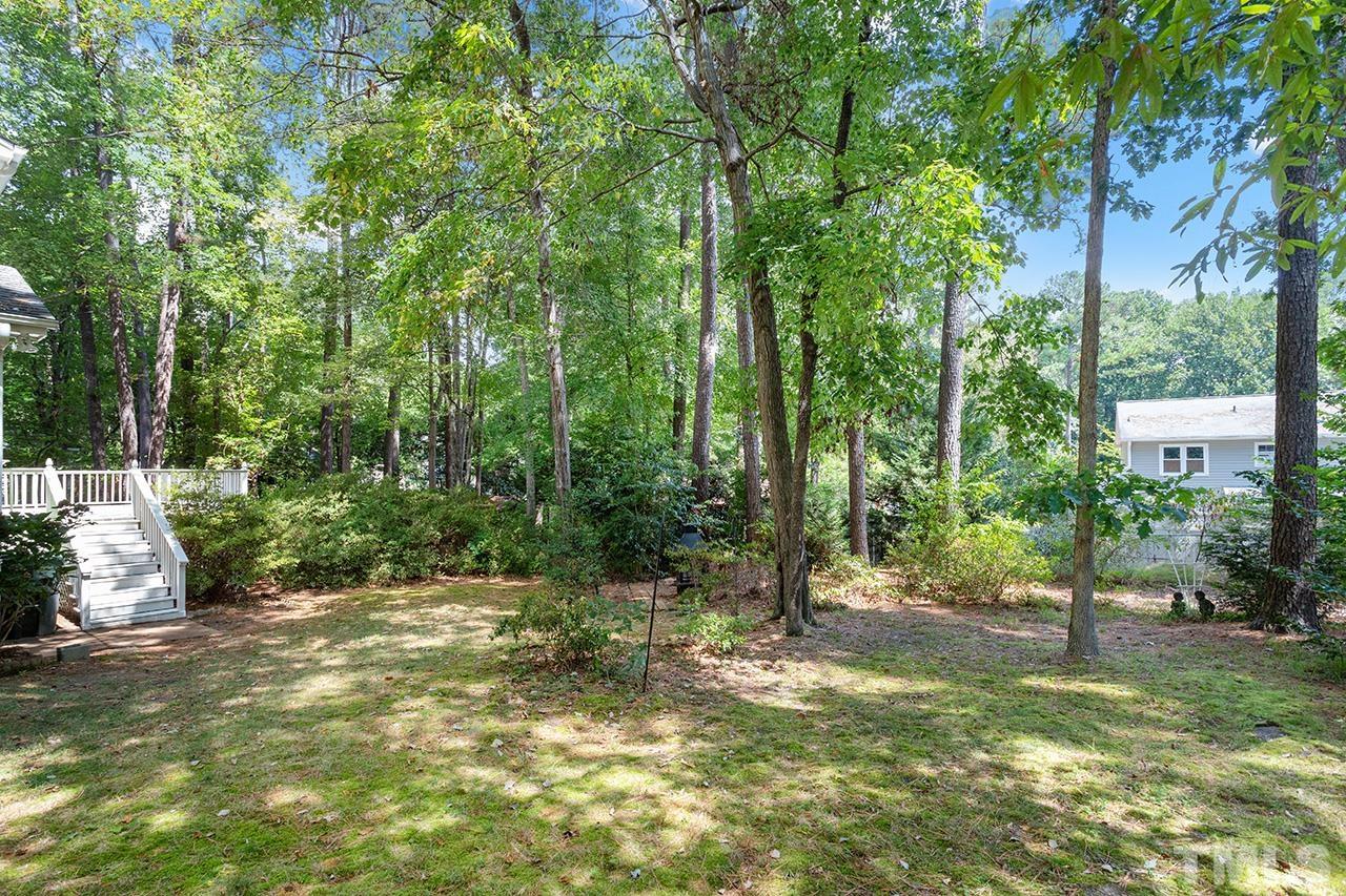 7416 Old Fox Trail Raleigh, NC 27613 - Photo 4 of 26 a view of a yard with a tree